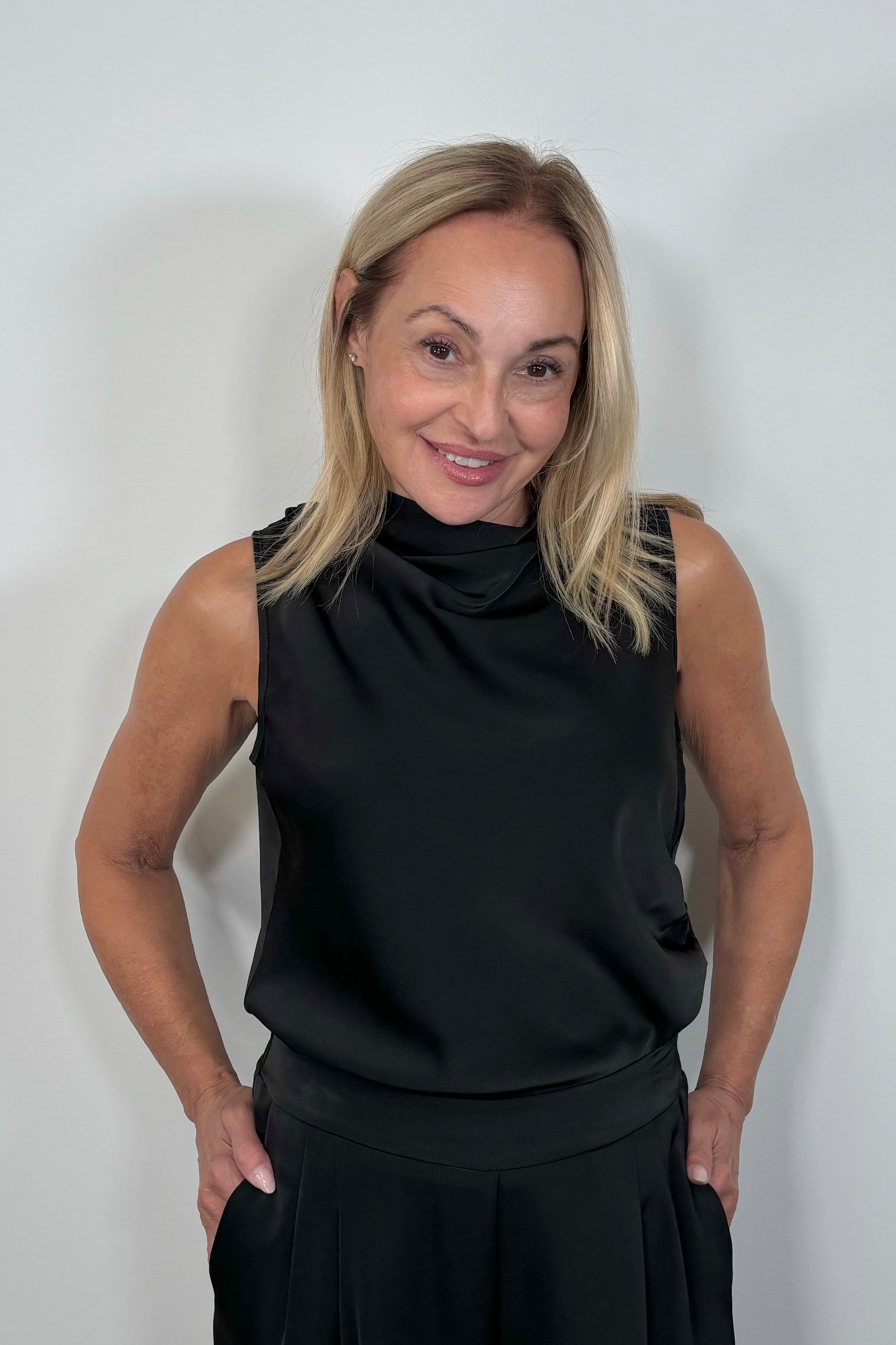 Front view of woman wearing a satin sleeveless top