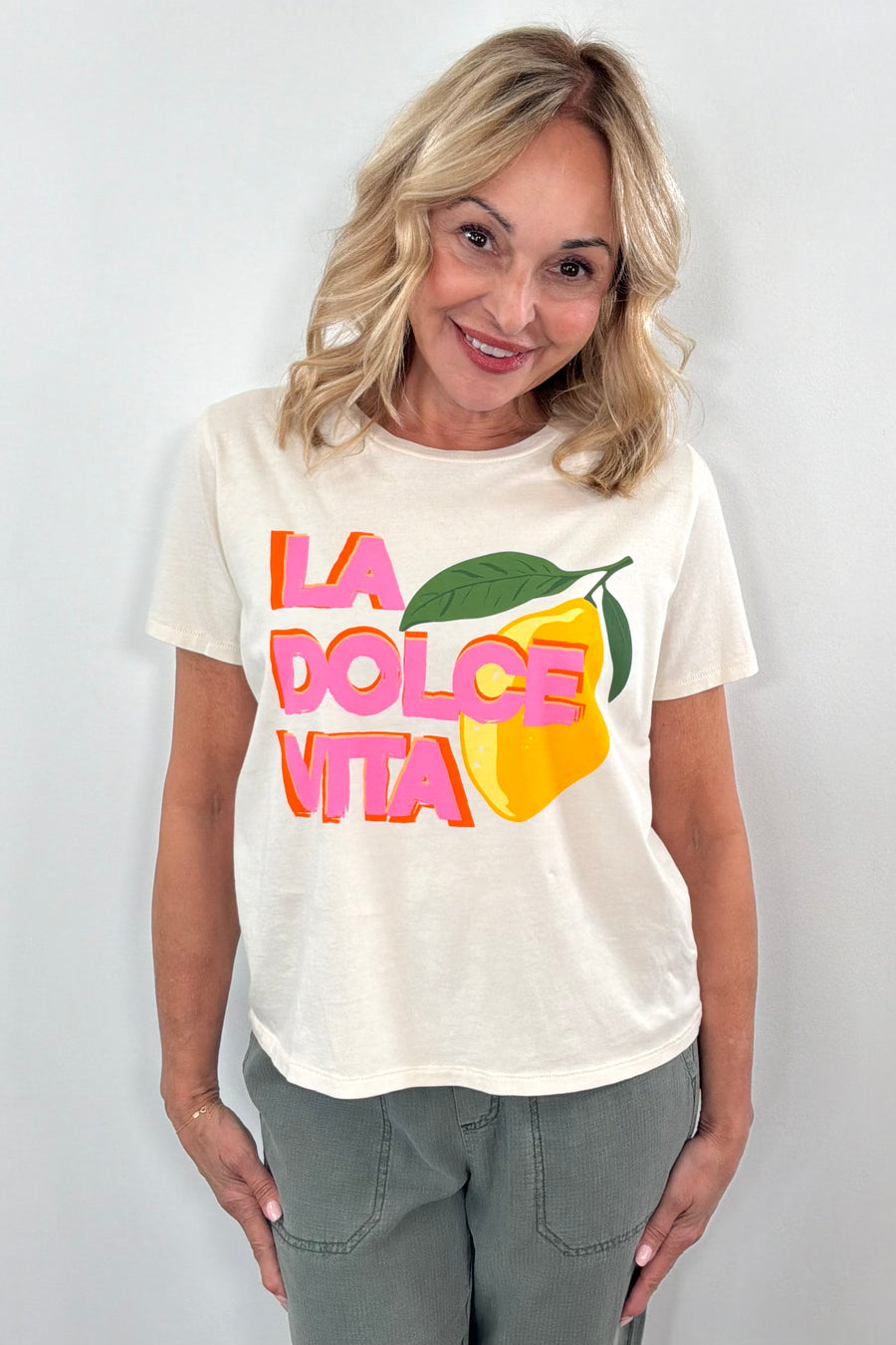Woman wearing while T shirt with ” la dolce vita” details