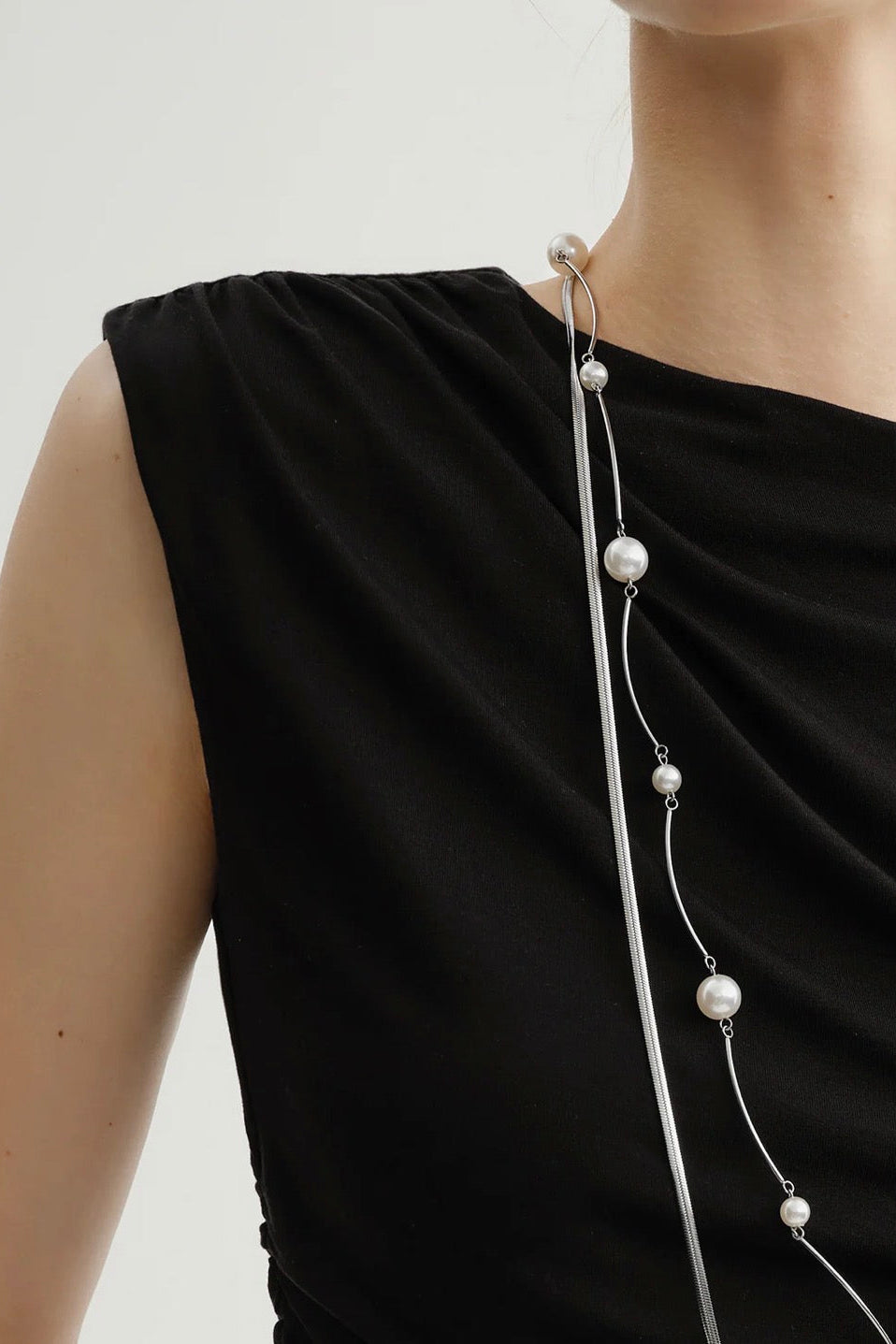 Close up of Woman wearing a black wide shoulder tank top