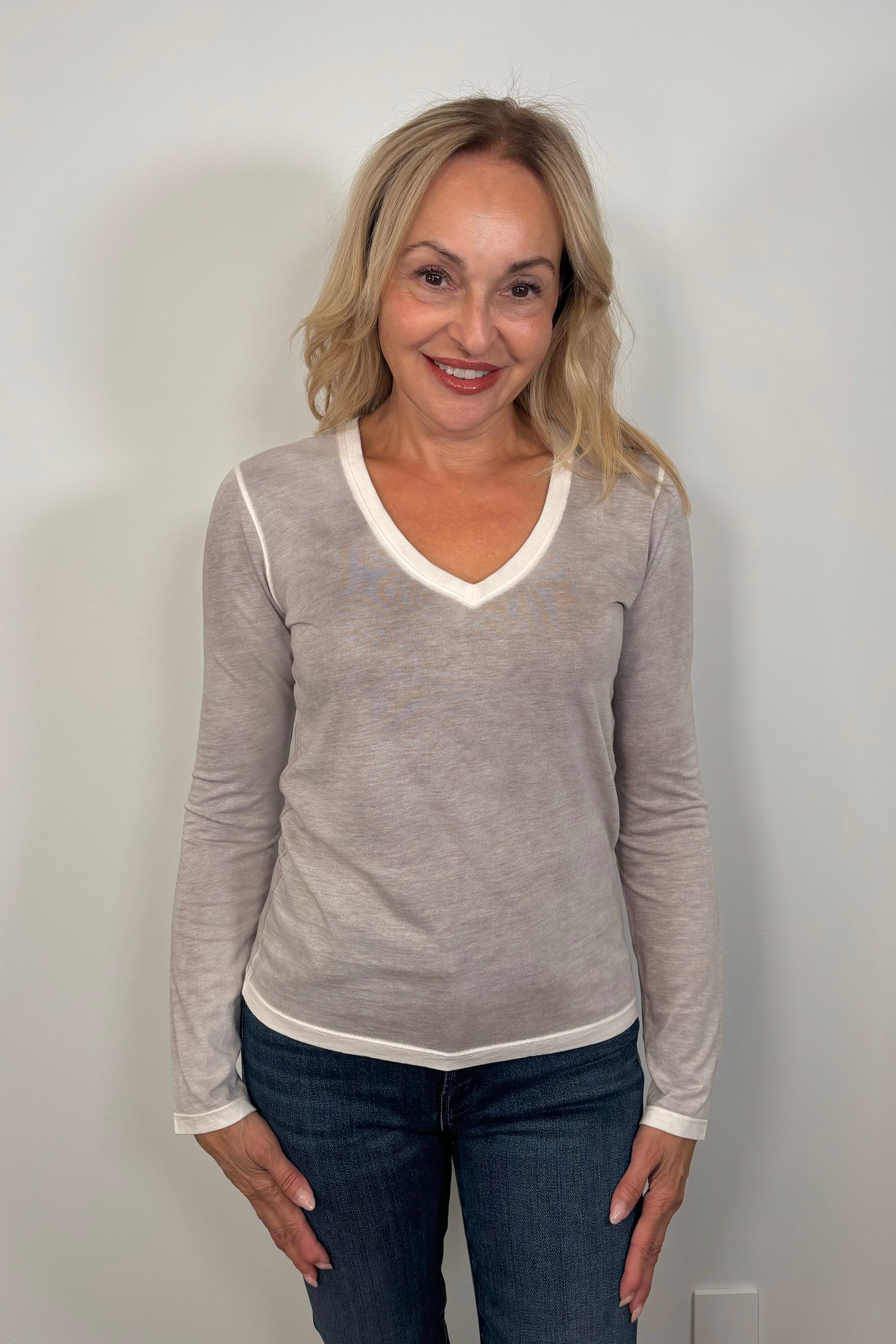 woman wearing a light gray long-sleeve shirt 