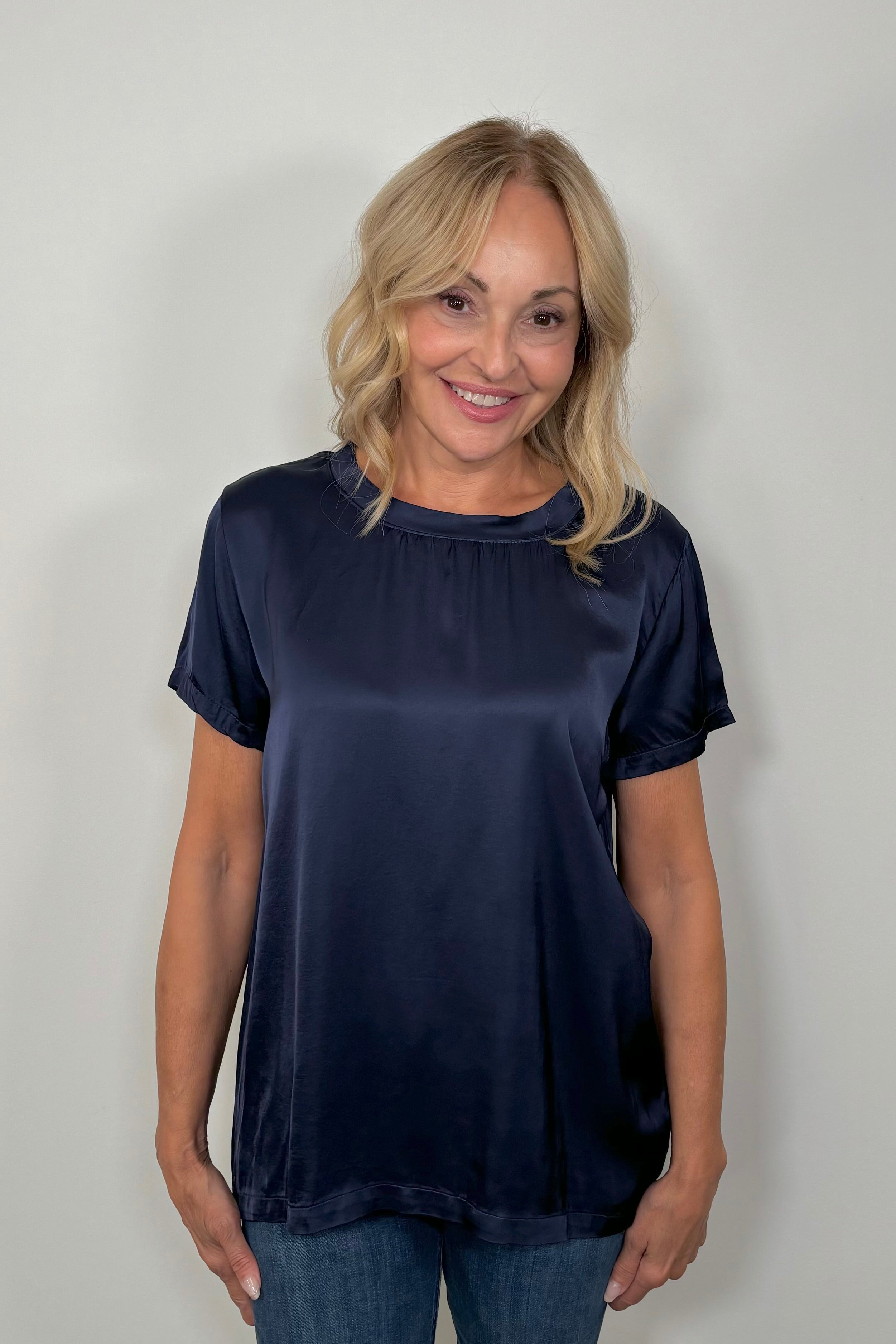 Front view of woman wearing a satin navy blue shirt
