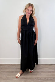Woman wearing a black halter neck maxi dress