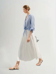 Side view of Woman wearing a blue button up shirt