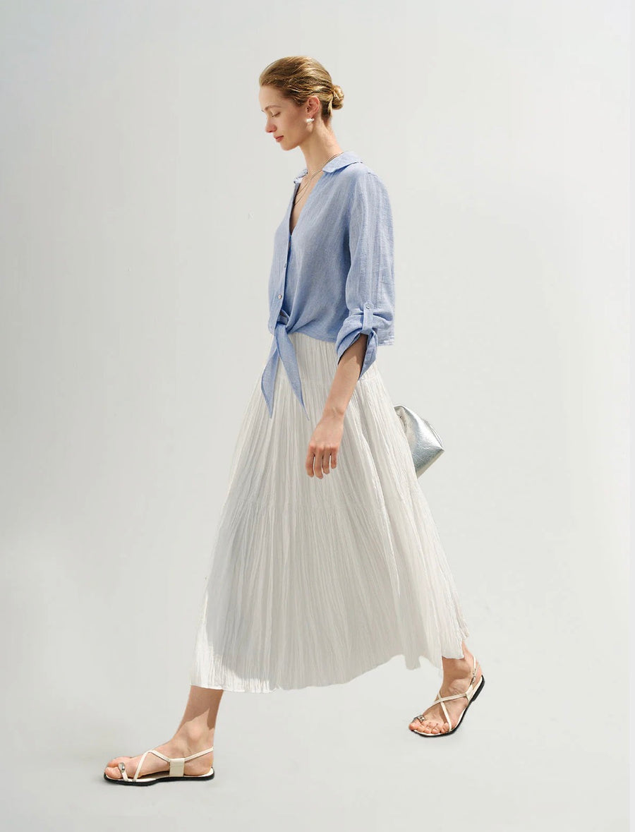 Side view of Woman wearing a blue button up shirt