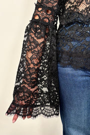 Woman wearing a lace long bell sleeve top
