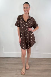 woman wearing a brown short shirt dress with gold detailing