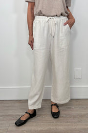 Front facing woman wearing cropped light weight  white pants