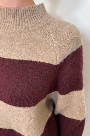 Close-up of a woman wearing a Sweater with burgundy stripes 