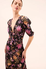 Woman wearing a floral dress with a plain background