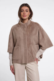 woman wearing brown fur high neck cape