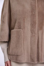 woman wearing brown fur high neck cape
