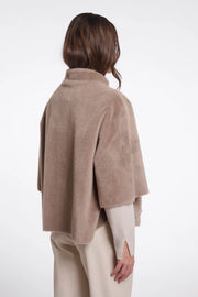 woman wearing brown fur high neck cape