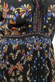 close up view of woman wearing a black v-neck maxi dress with a colourful pattern