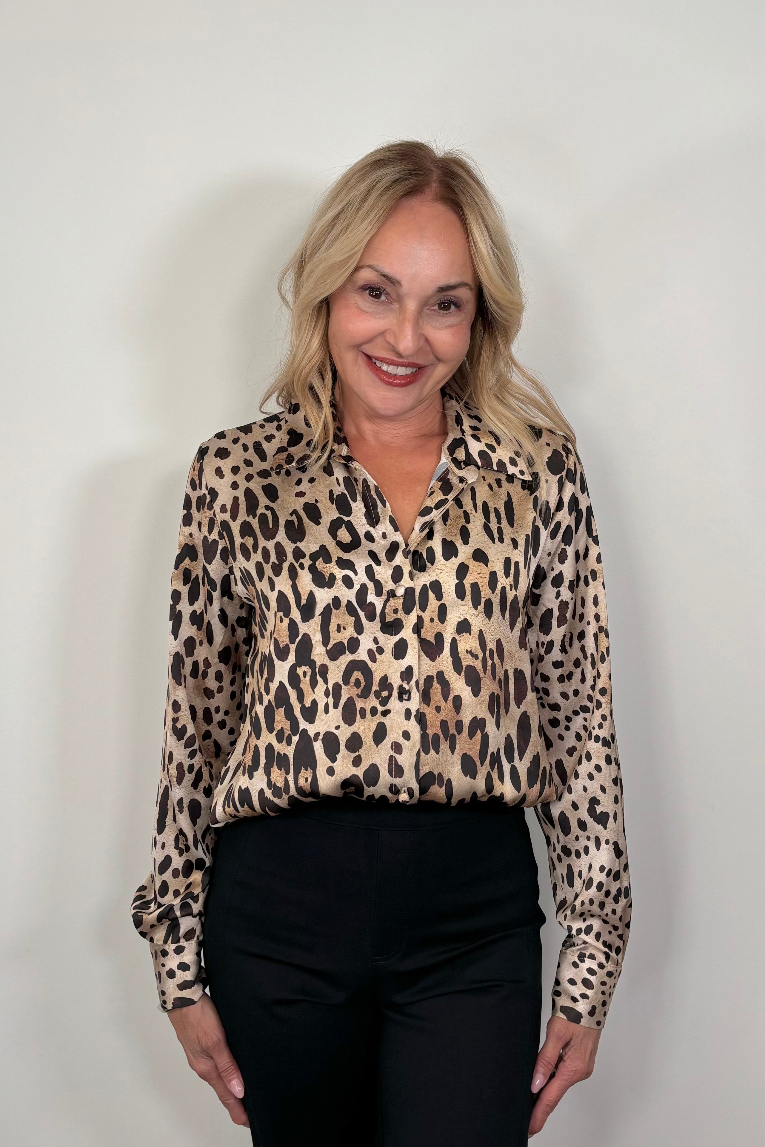 woman wearing a leopard print button down shirt
