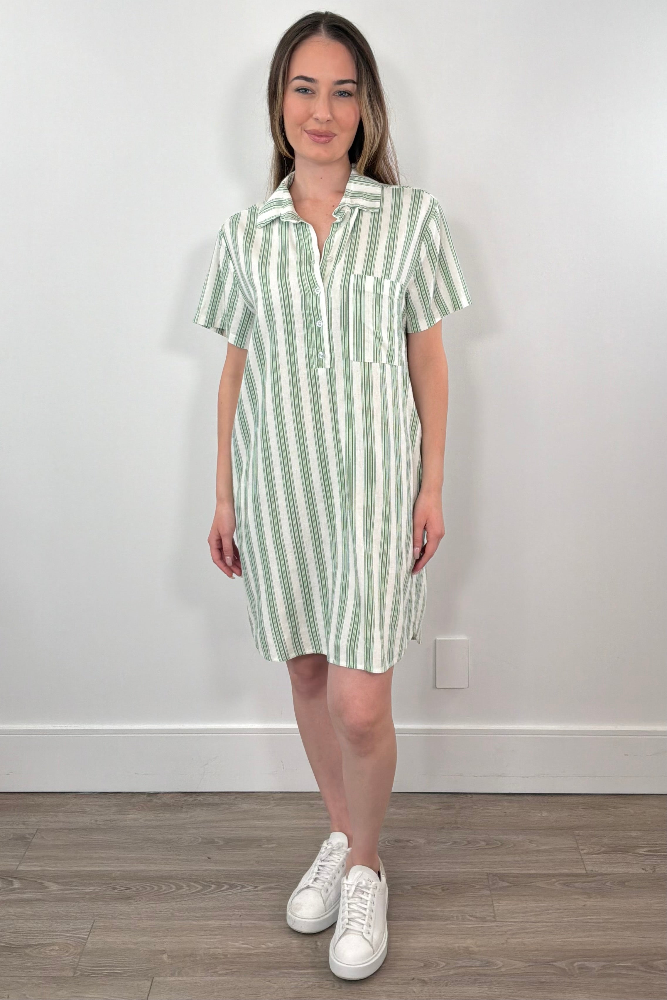Woman wearing a light green and white striped shirt dress with a collar