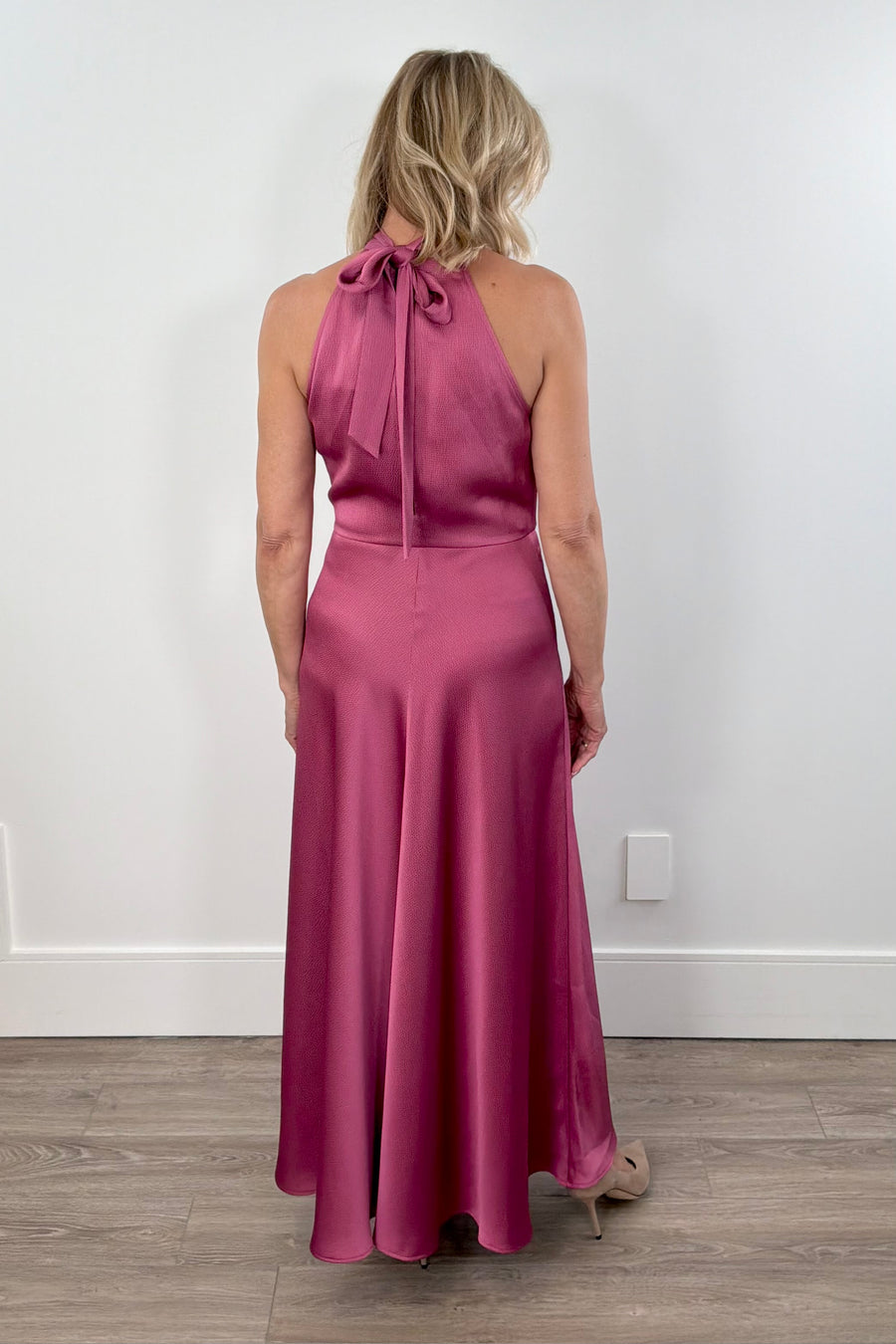 Woman wearing a pink sleeveless satin dress