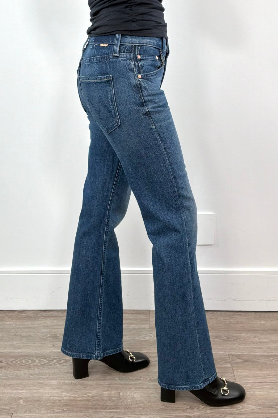 woman wearing straight leg boot cut blue jeans