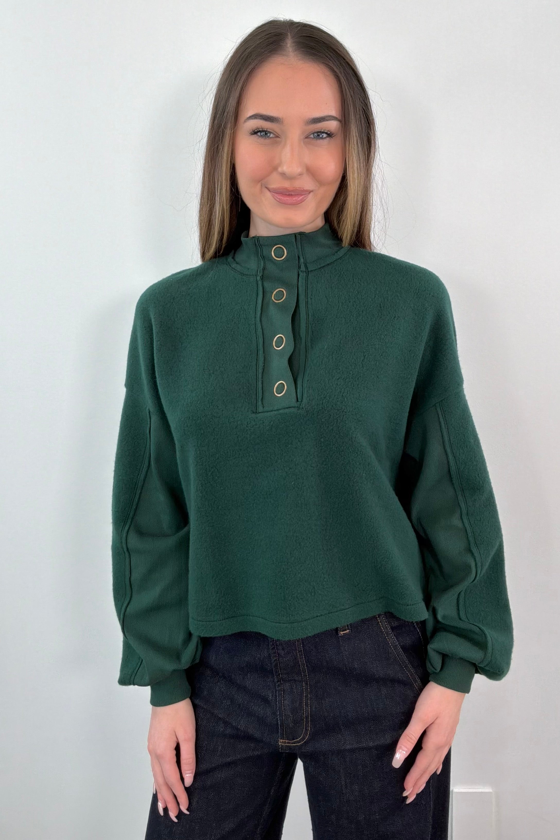 woman wearing a green fleece henley sweatshirt