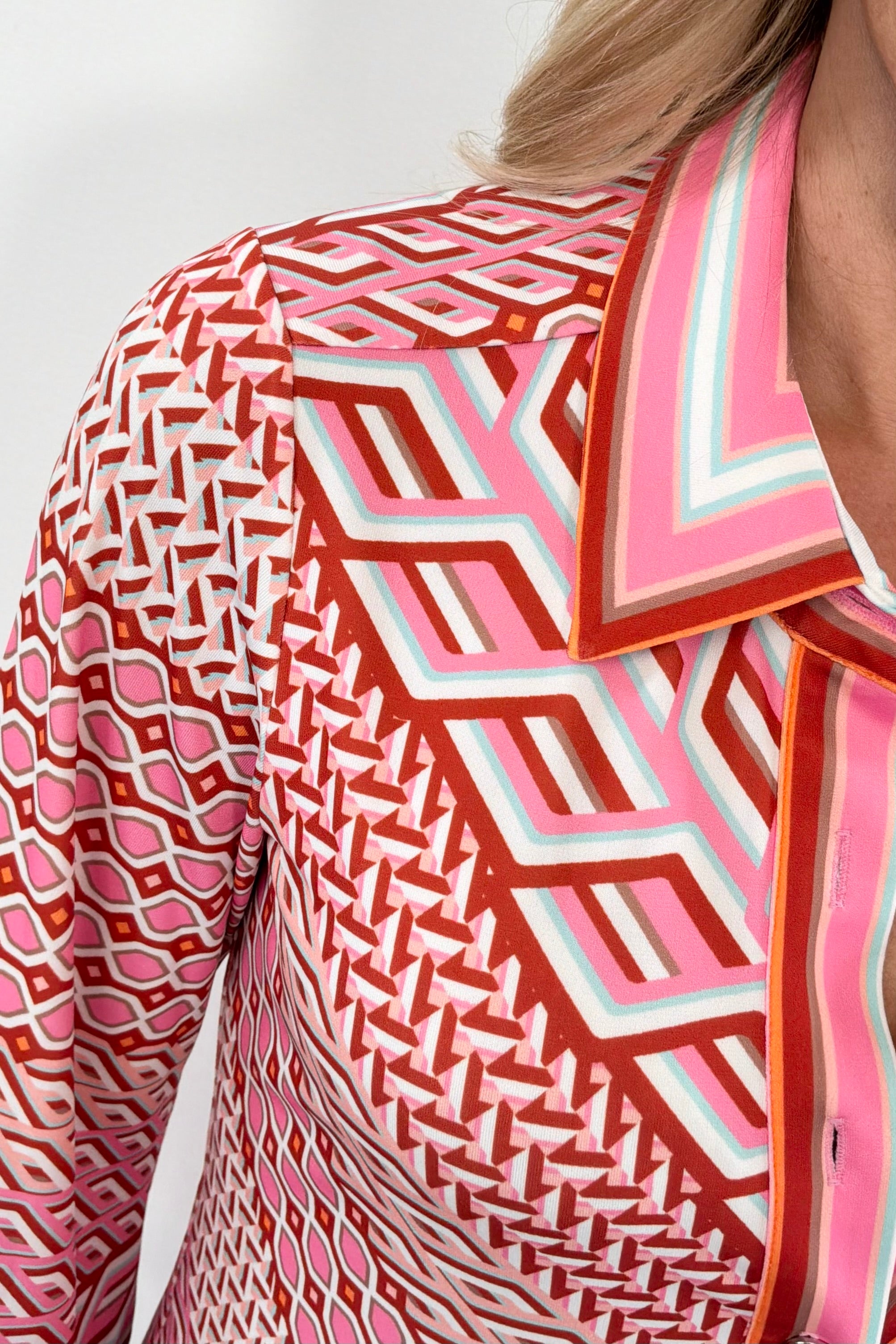 Close up of Woman wearing a red and pink patterned dress