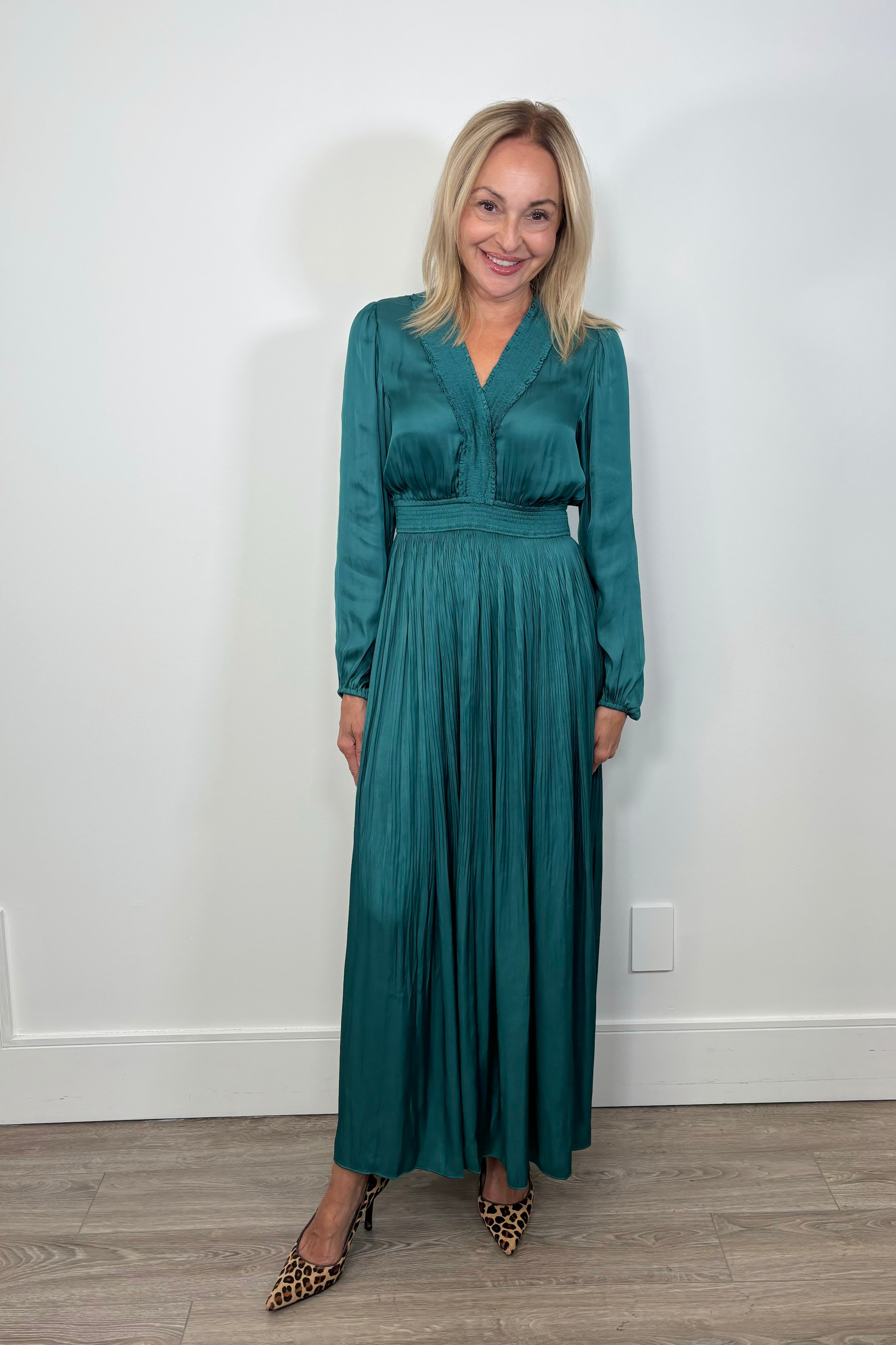 Front view of woman wearing a green maxi long sleeve silk dress
