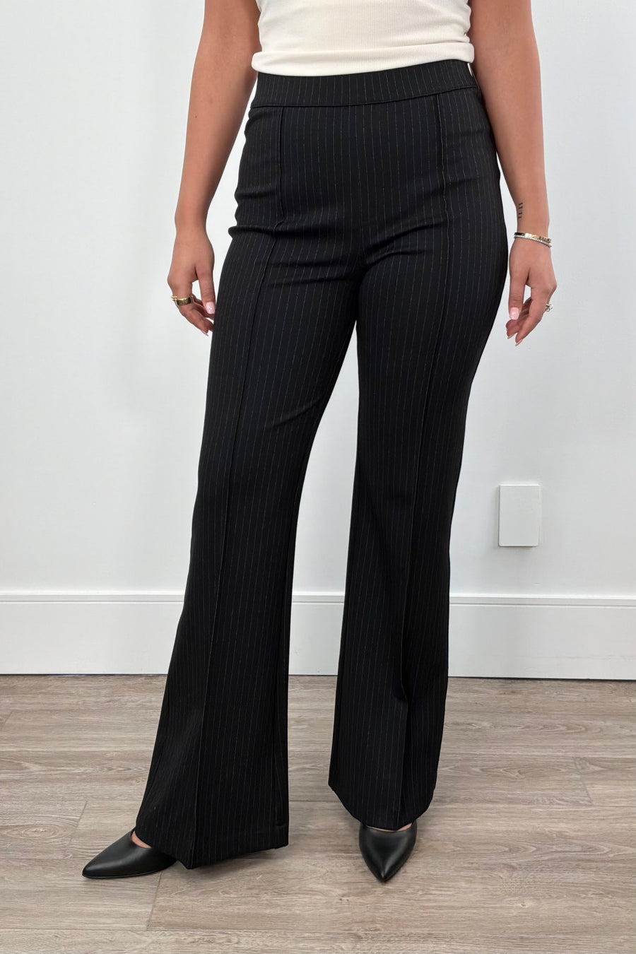 Person wearing black pinstripe pants