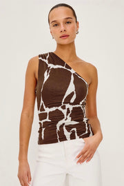 Woman wearing a brown and white printed off one shoulder top