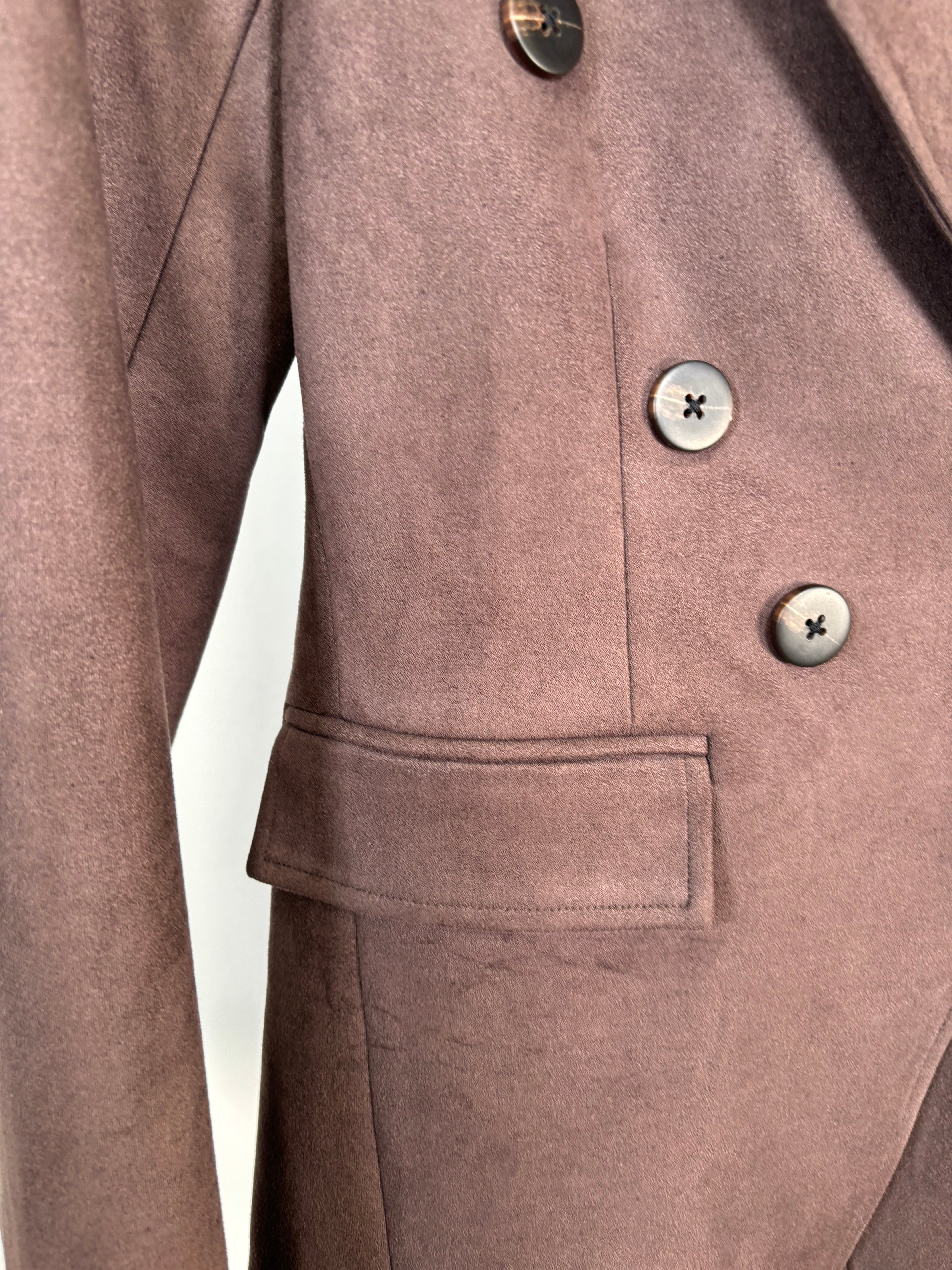 Close-up of a brown coat with buttons and a pocket on a white background