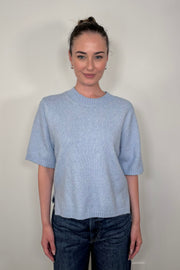 Front view of woman wearing a light blue half sleeve sweater