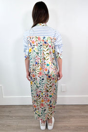 woman wearing a white and blue striped dress with a silk floral patterns