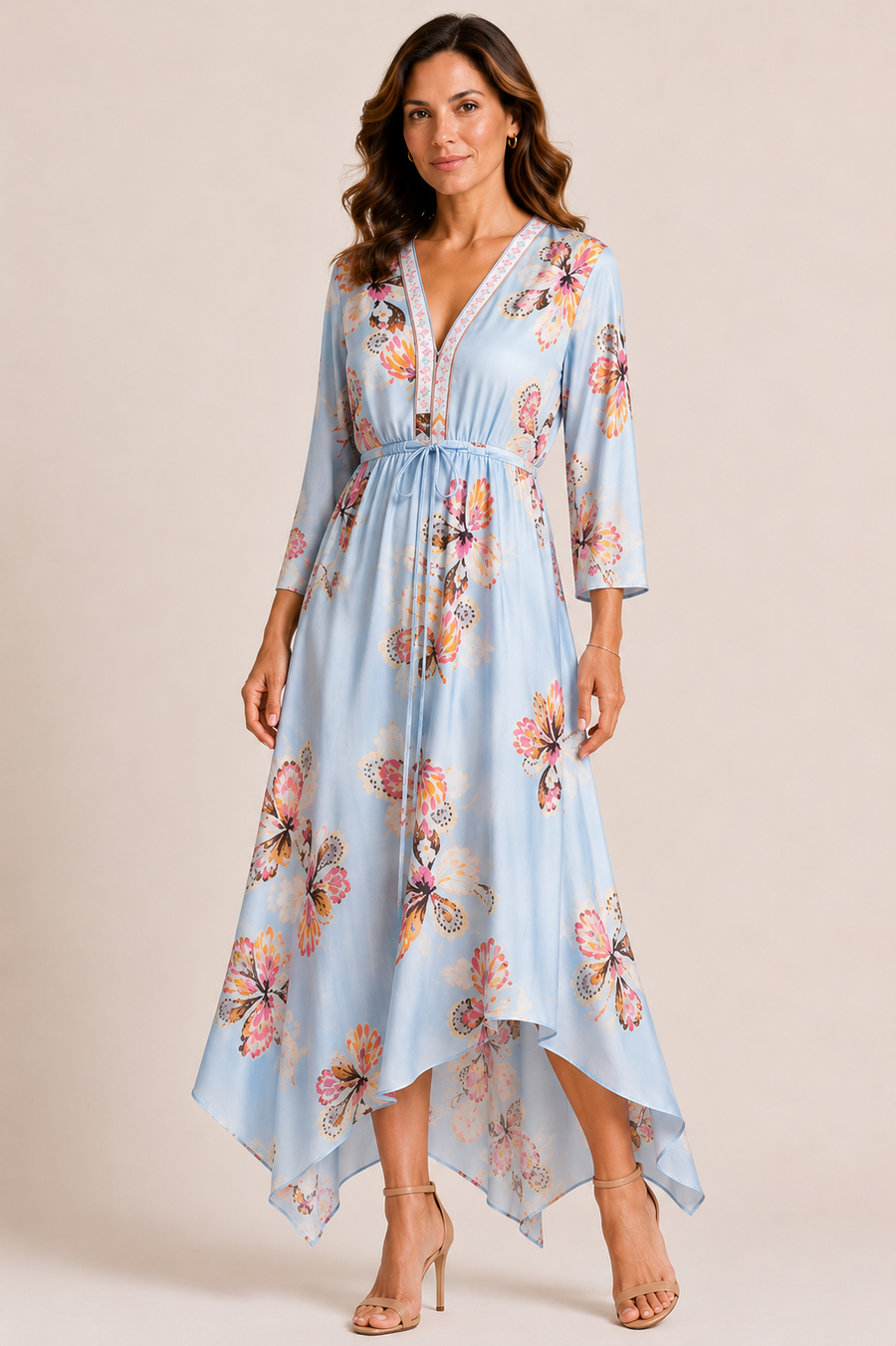 Woman wearing a light blue floral kimono dress with tie around the waist 