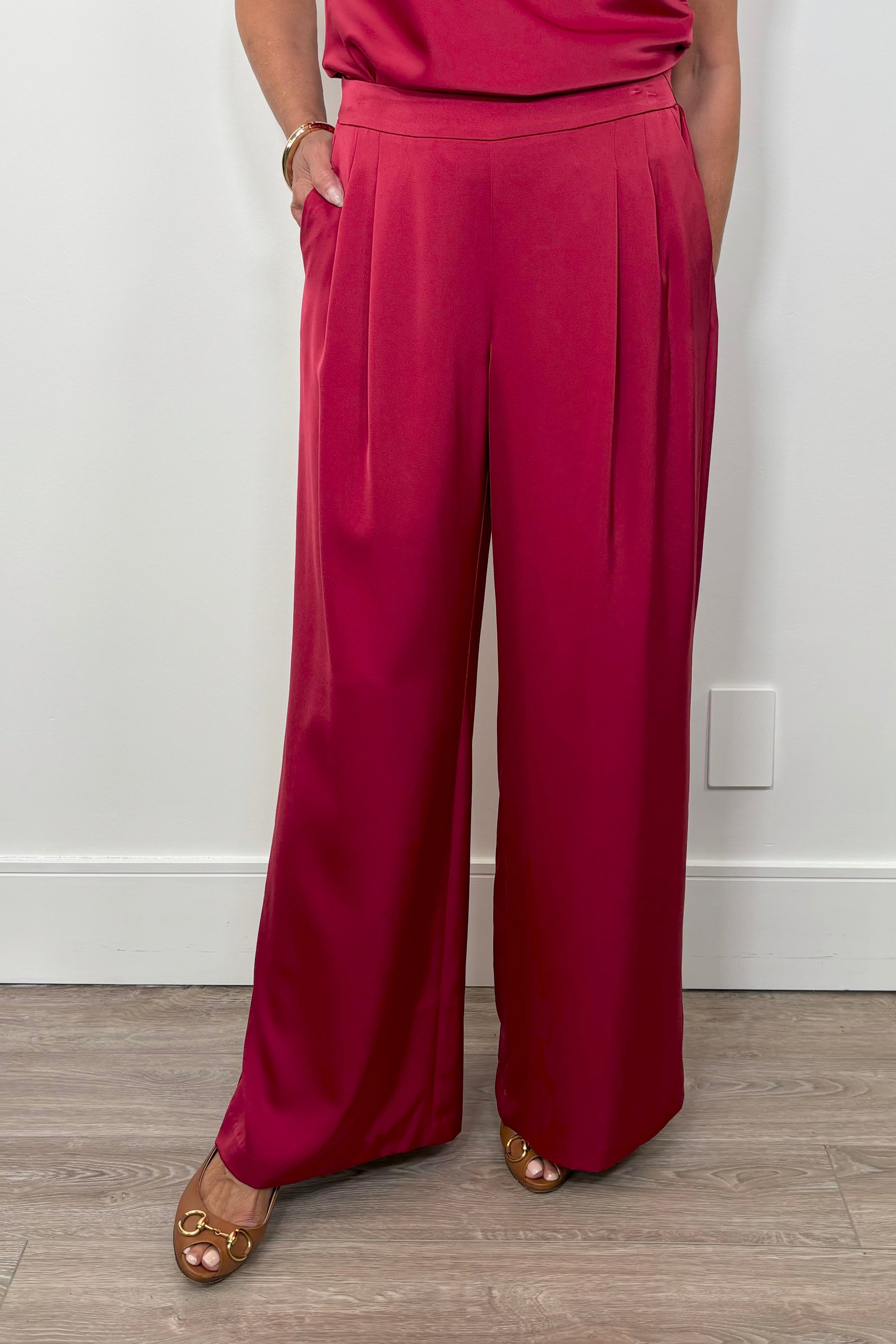 Front view of woman wearing a satin red pant