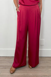 Front view of woman wearing a satin red pant