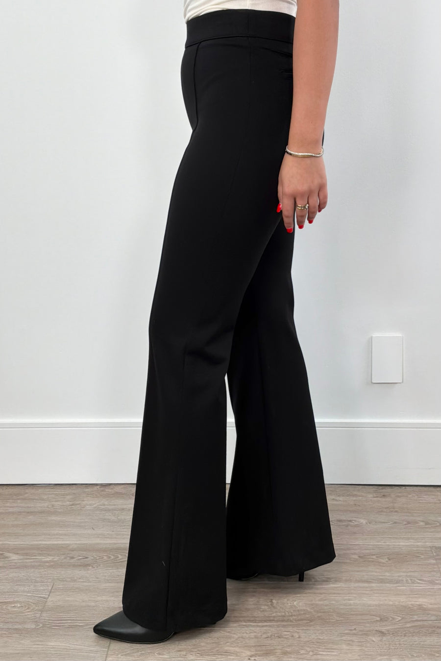 Person wearing black flared pants