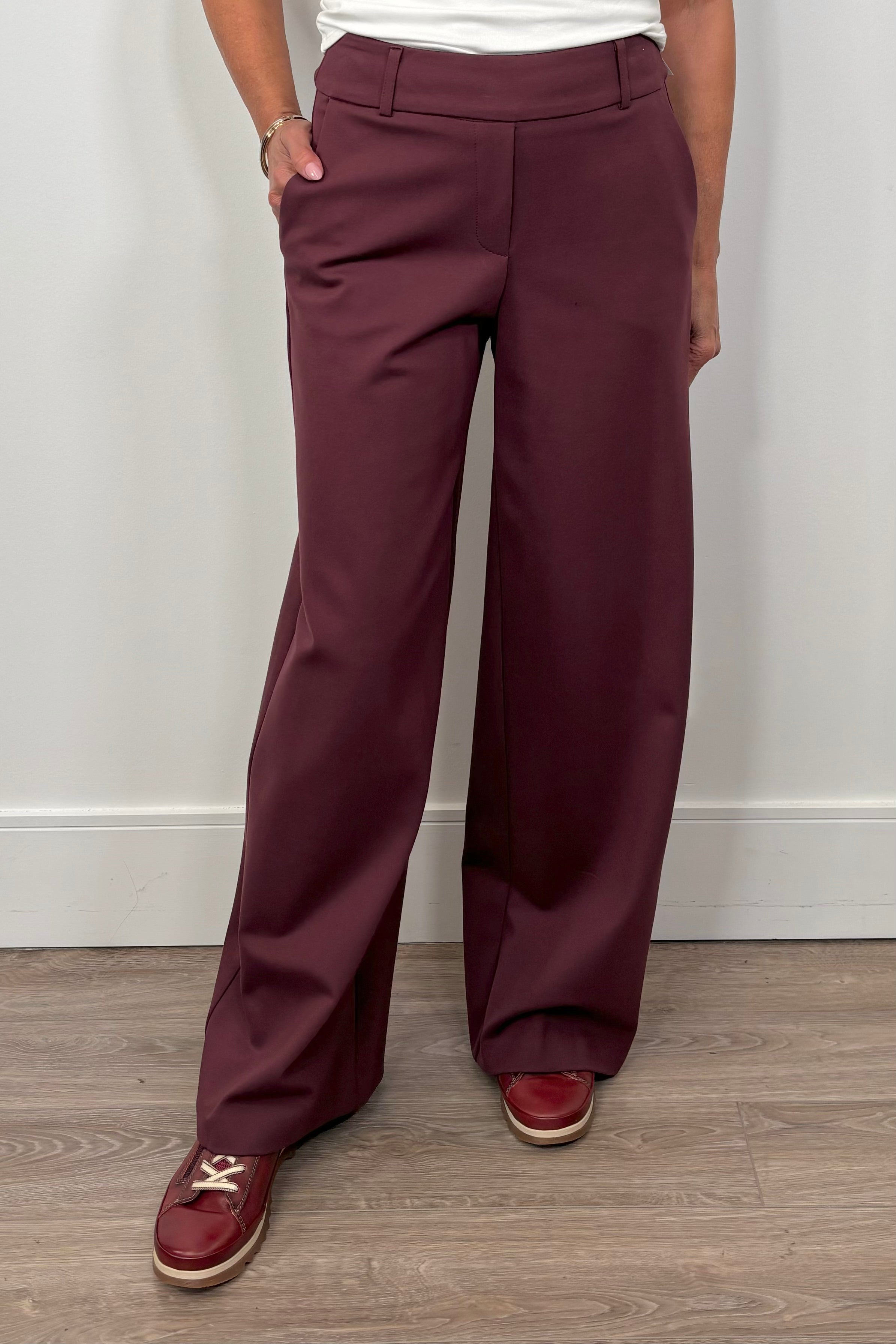 woman wearing a pair of burgundy pants
