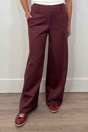 woman wearing a pair of burgundy pants