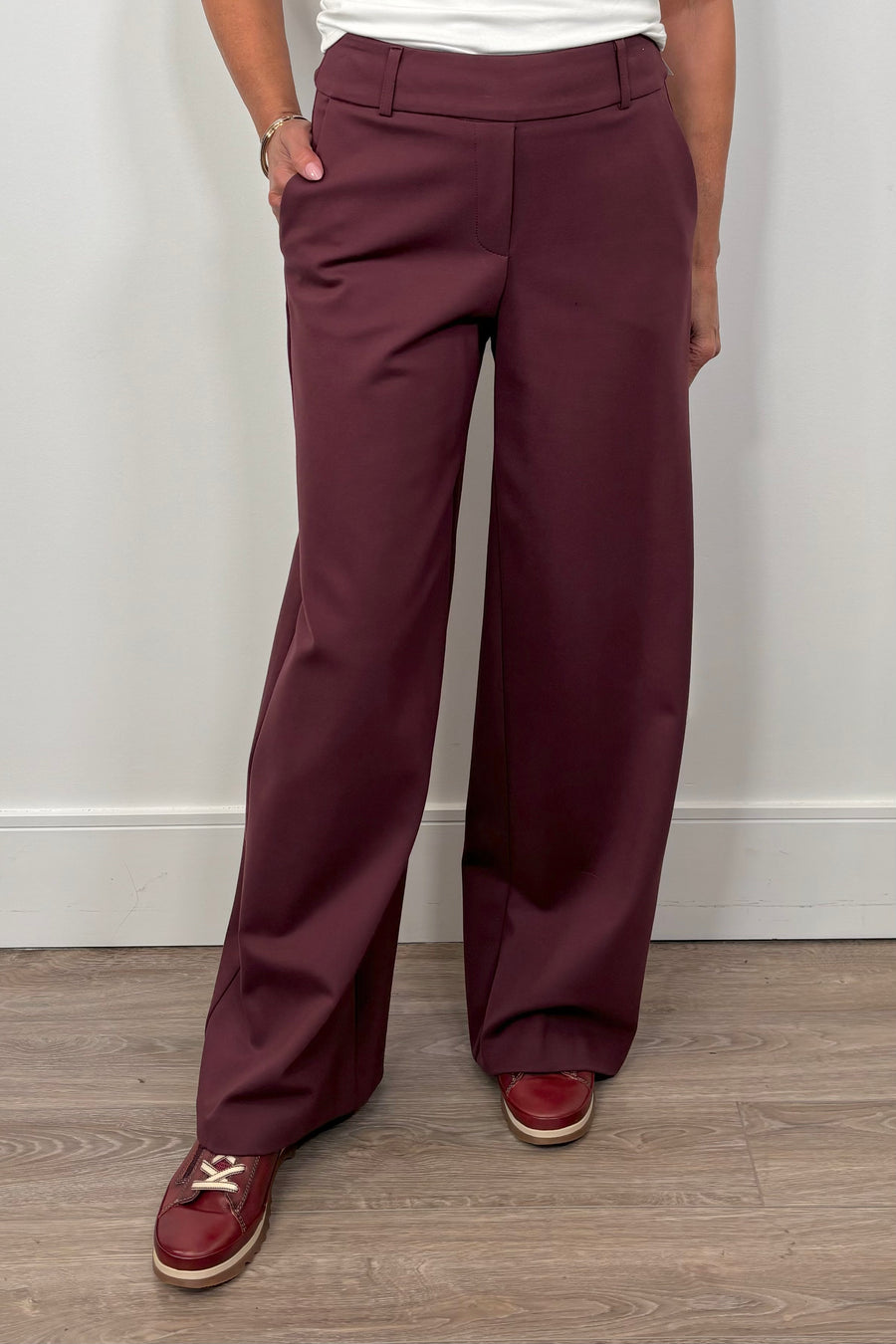 woman wearing a pair of burgundy pants