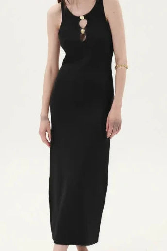 Woman wearing a black knit dress with gold neck details