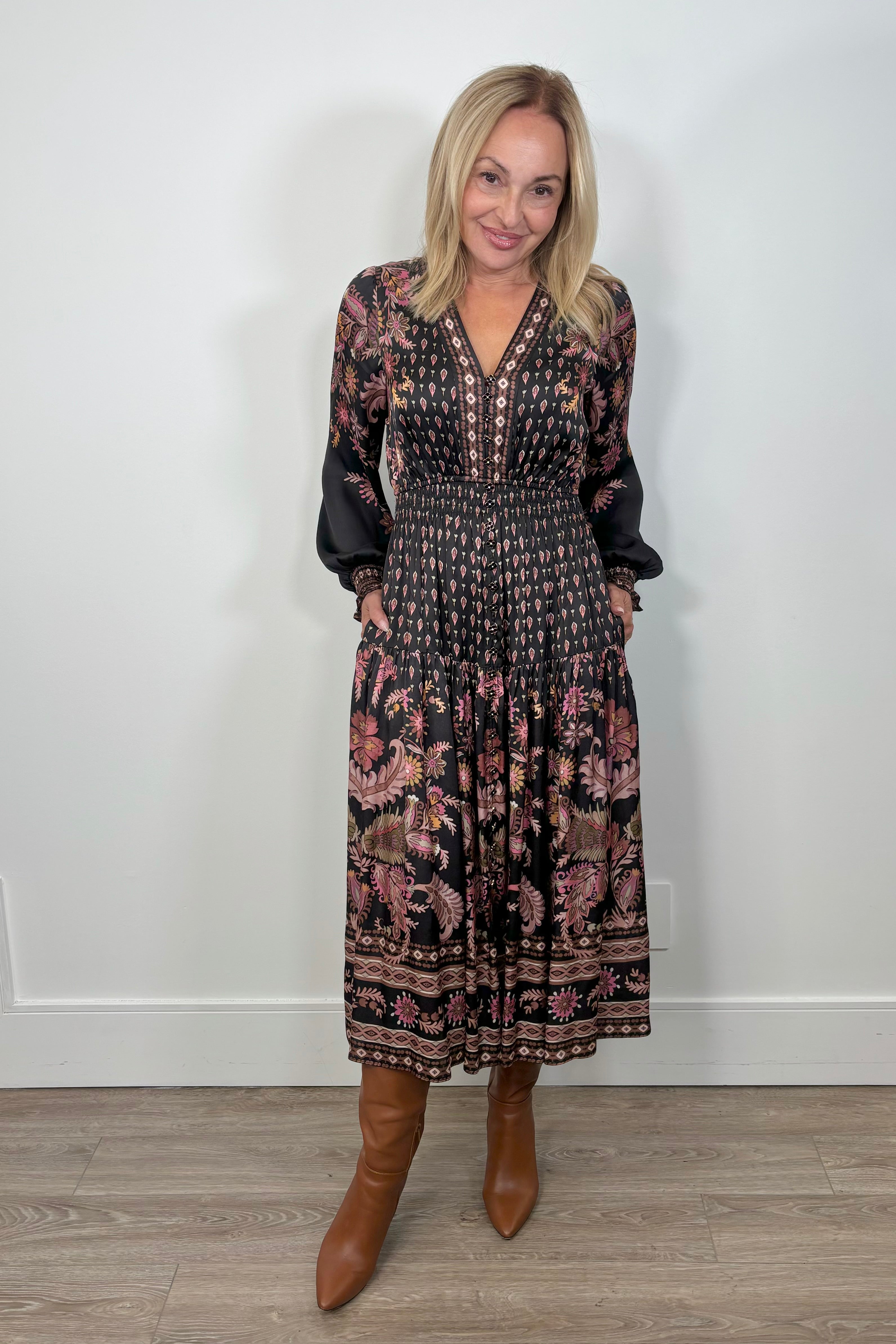 Front view of a woman wearing a silk midi long sleeve patterned dress