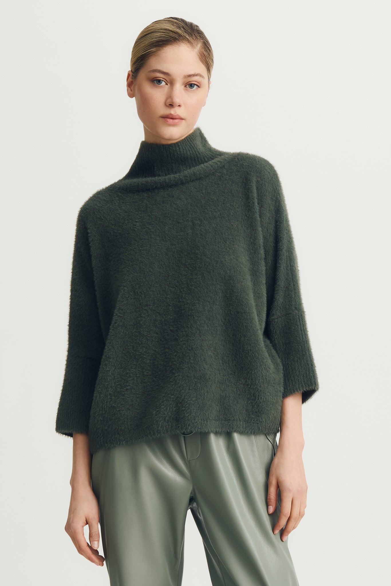 Woman wearing a green half sleeve hairy sweater
