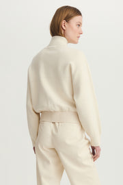 Back view of a woman wearing a nix media bomber jacket