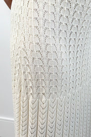 Closeup of Woman wearing a cream knit midi skirt with elastic waistband