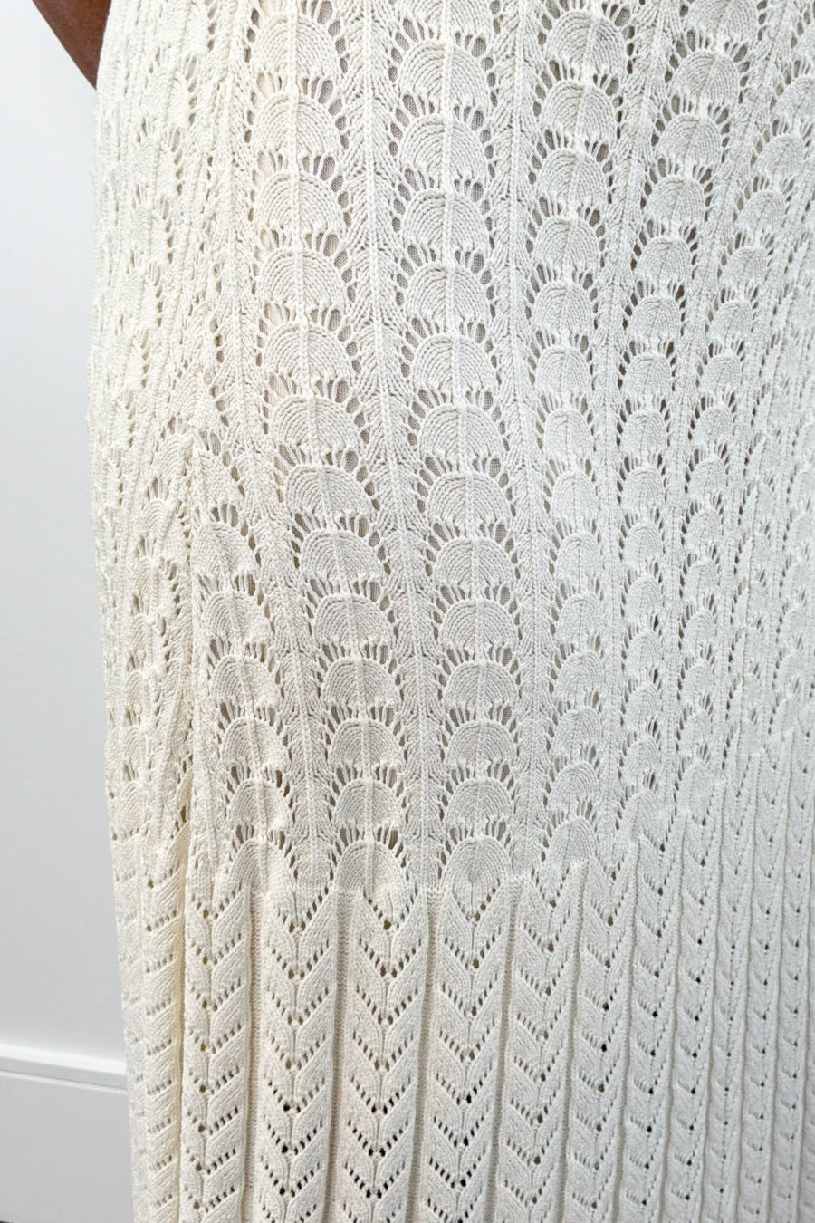 Closeup of Woman wearing a cream knit midi skirt with elastic waistband