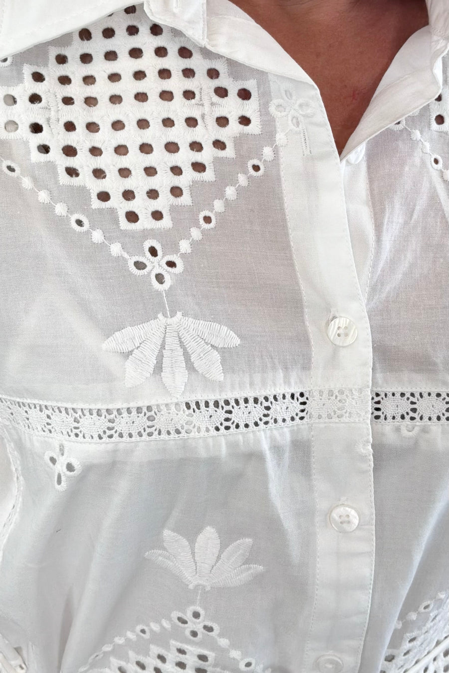 Close-up of a white embroidered dress