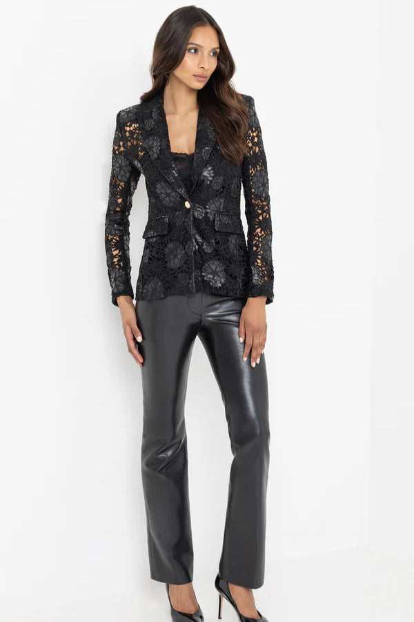 Full body image view of a woman wearing a black lace and leahter blazer and pants