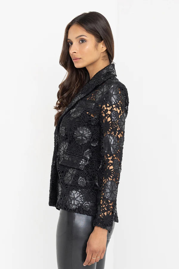 Side view of a woman wearing a black lace and leahter blazer