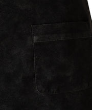 Close-up of a black textured fabric garment showing a rectangular patch pocket with matching black stitching.