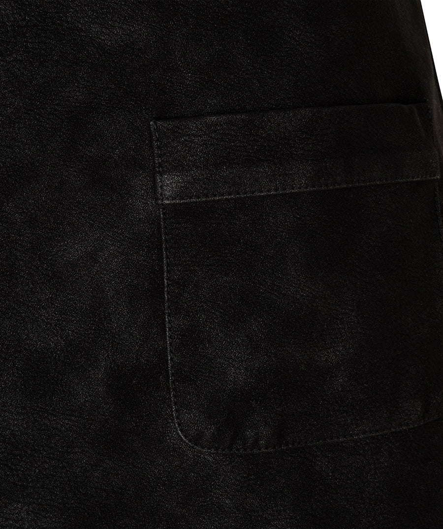 Close-up of a black textured fabric garment showing a rectangular patch pocket with matching black stitching.