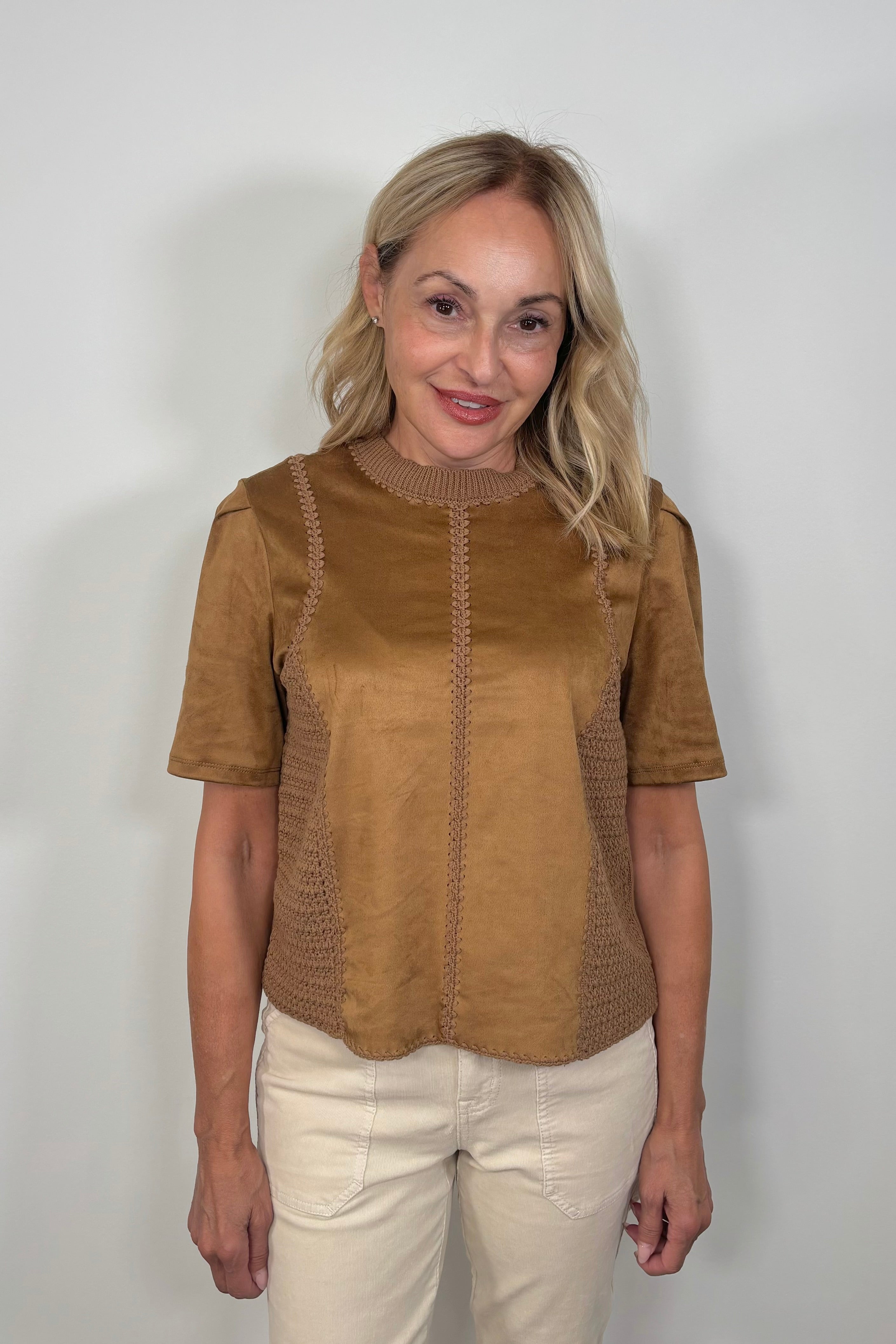 Woman wearing a suede leather and crochet top 