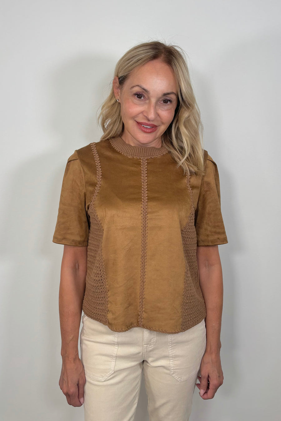 Woman wearing a suede leather and crochet top 
