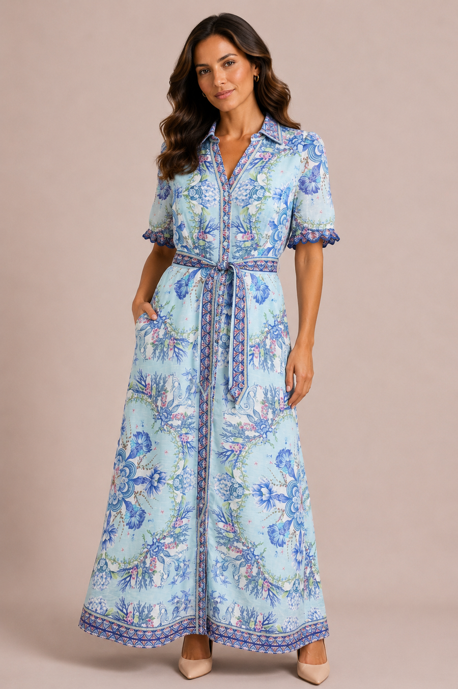 Woman wearing a long blue floral dress with detailed sleeves 